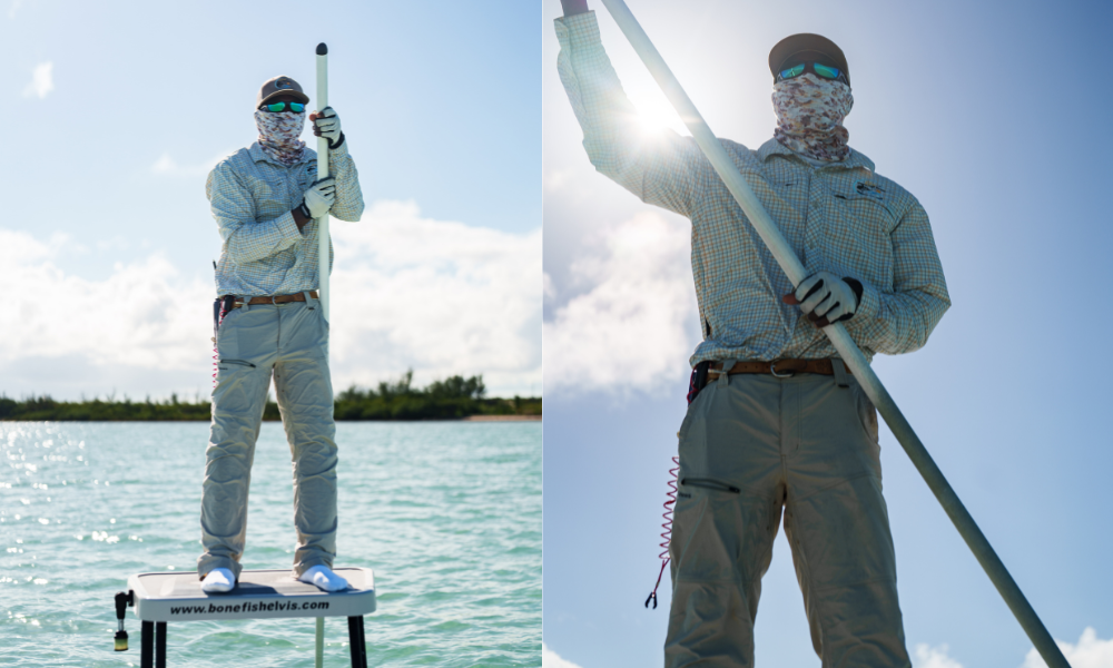 A guest at Caerula Mar Club stands on a platform in shallow Bahamian waters, wearing outdoor gear, sunglasses, and a hat, holding a long pole under the blue sky with sunlight.